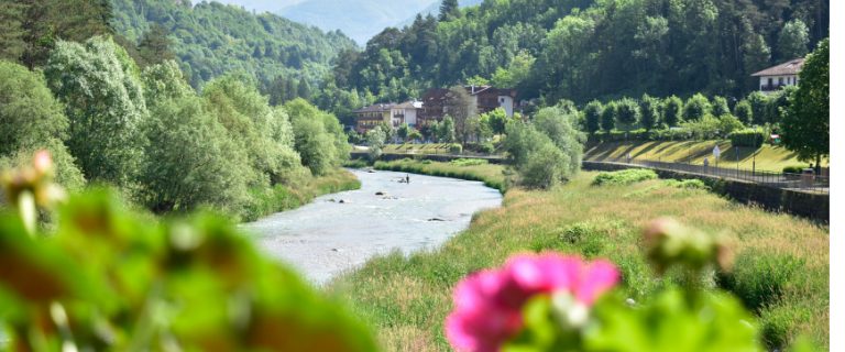 River and green mountain landscape near Comano Terme